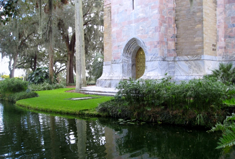 a large building sitting next to a small body of water