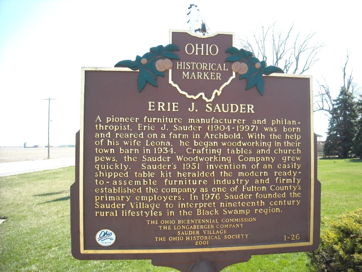 a historical marker at the entrance to the park