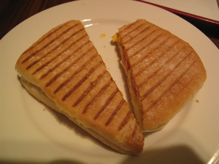 a grilled sandwich sitting on top of a white plate