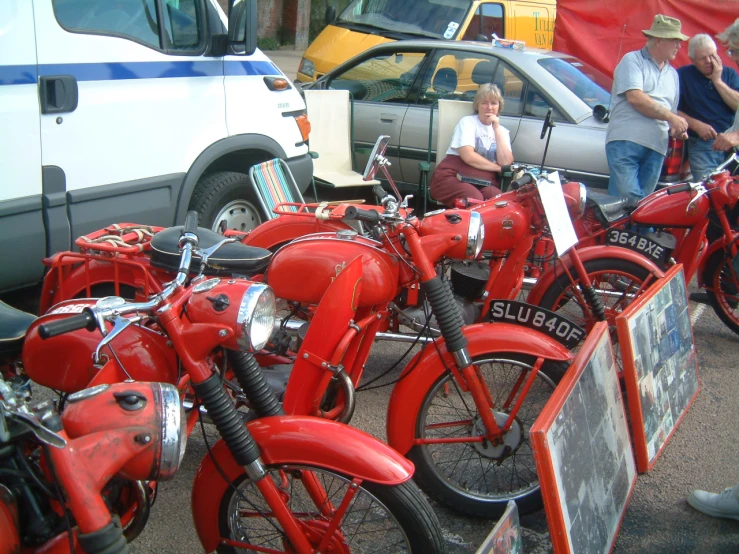 red motorcycles are shown parked on the street