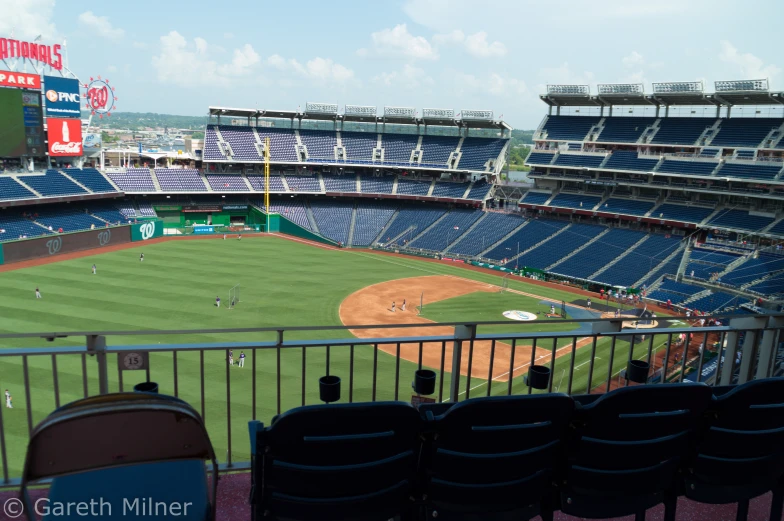 a baseball field is in the background as view from the upper balcony