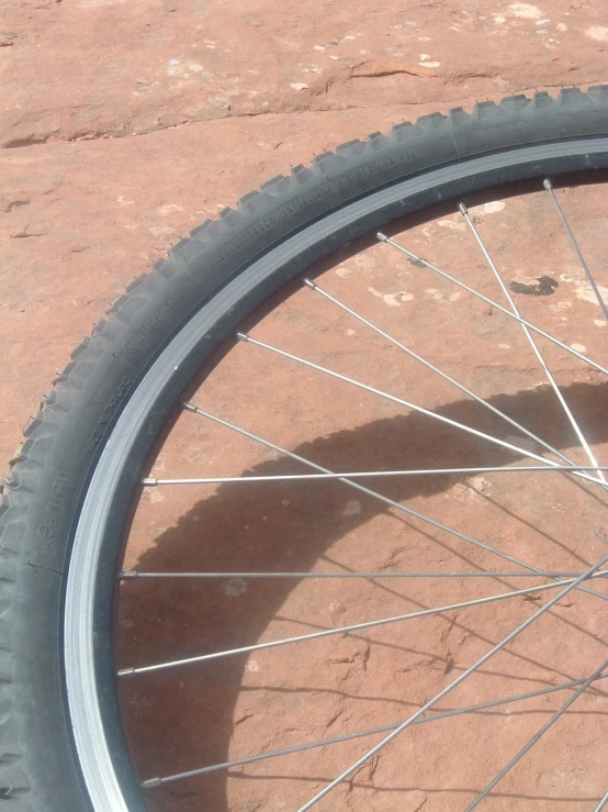 a bicycle tire sitting in front of a bicycle wheel