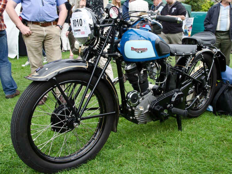 motorcycle on grassy area at outdoor event in open field