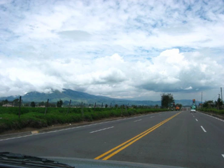 a car traveling down an empty rural highway