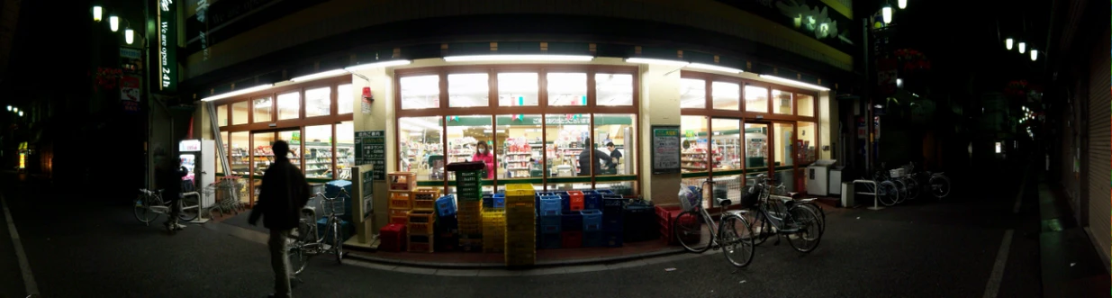 several bicycles parked outside of a store at night