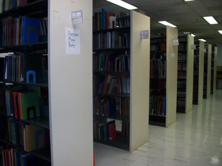 the shelves are filled with many books and filebins