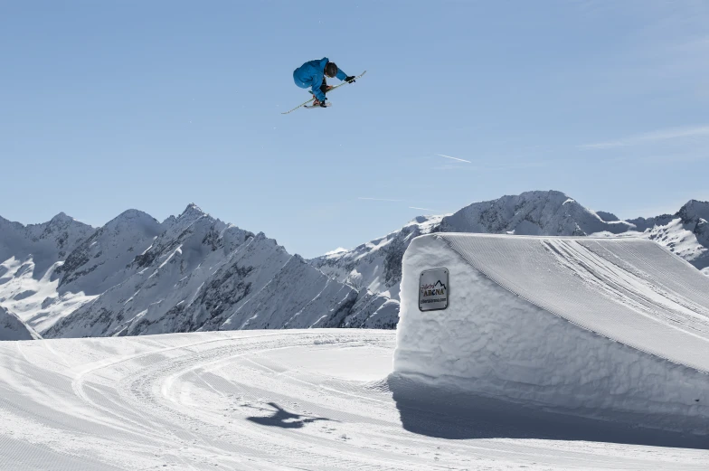 a man flying through the air while riding a snowboard