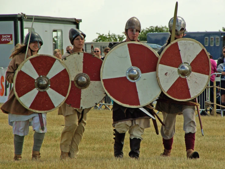 people dressed in armor with helmets and spears