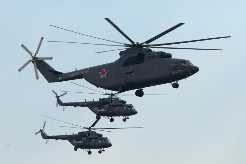 two army chinels are being lifted by a helicopter