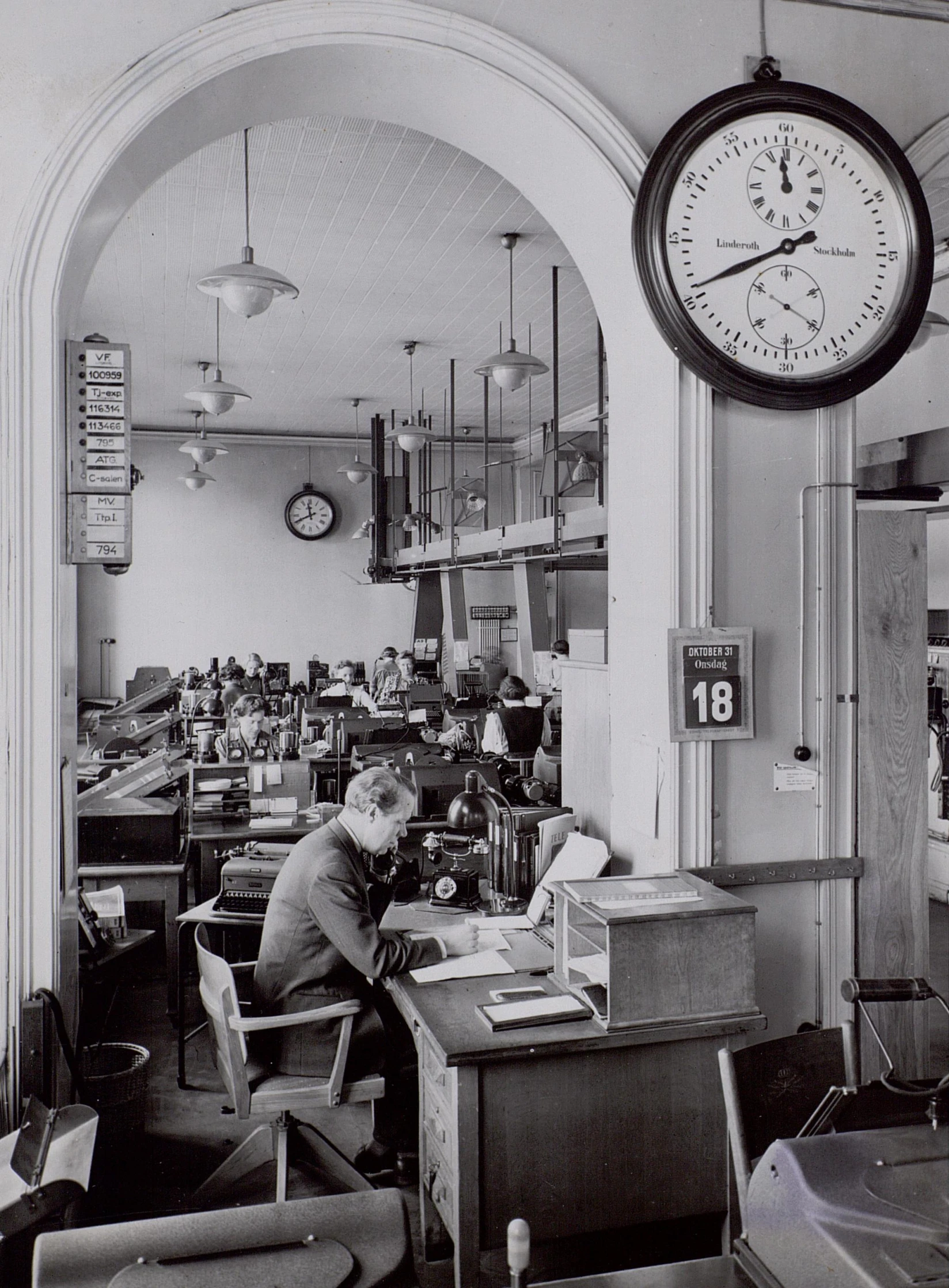 an old fashioned picture of a man working at a desk