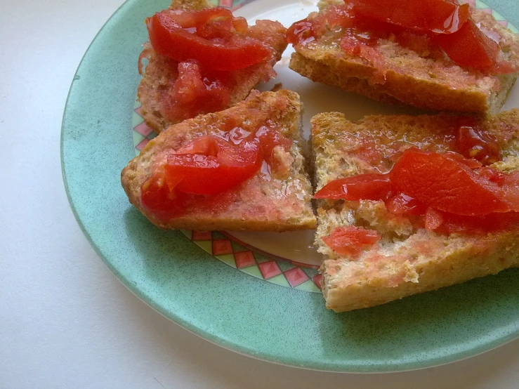 several pieces of bread with tomatoes on a plate
