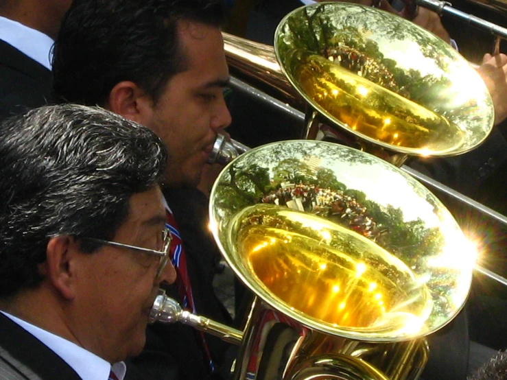 two guys playing musical instruments and in suits