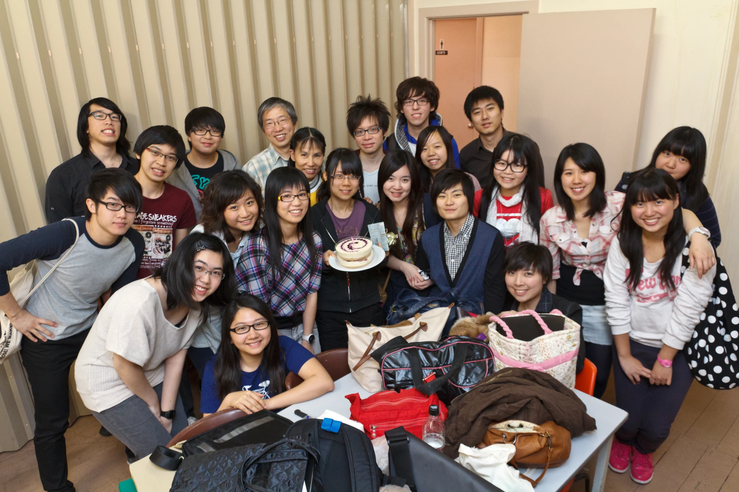 a group of young asian people standing around