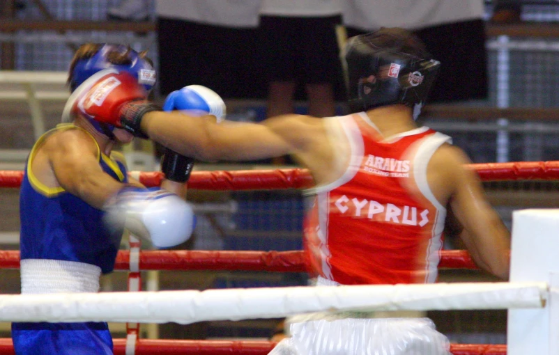 a man wearing blue shorts is standing in the ring