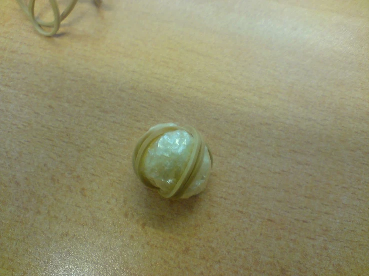 a small white stone sitting on top of a wooden table