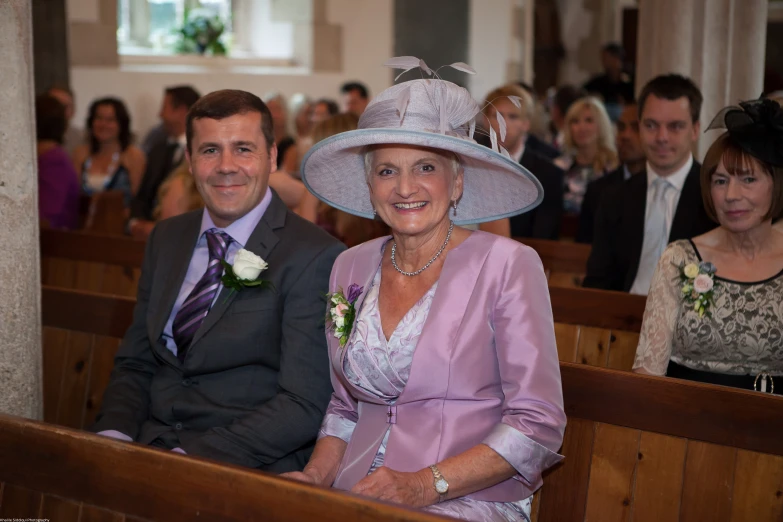 a man and woman sitting in the church at wedding