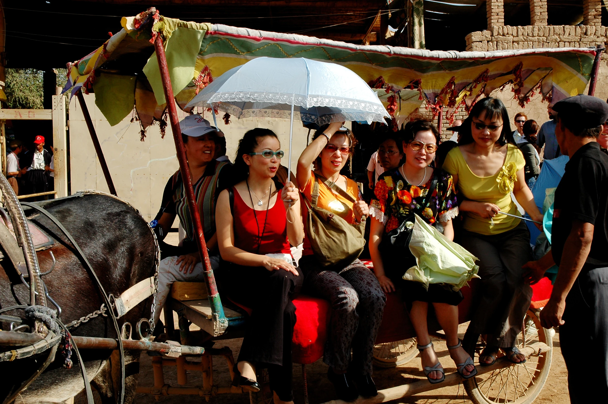 several people riding on a horse drawn carriage