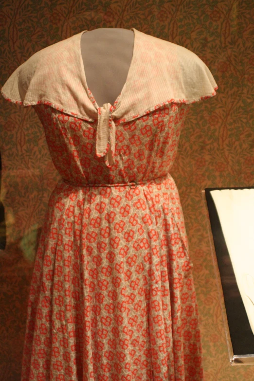 a dress that is on display near a lamp