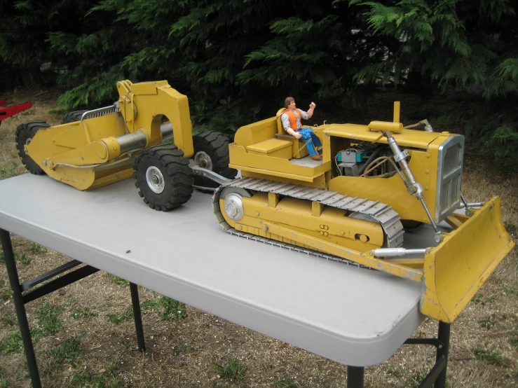 an older model of a construction equipment and a child