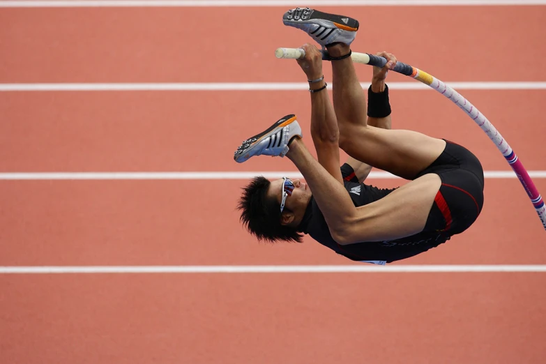 an athlete doing a backflip in the air with a long jump