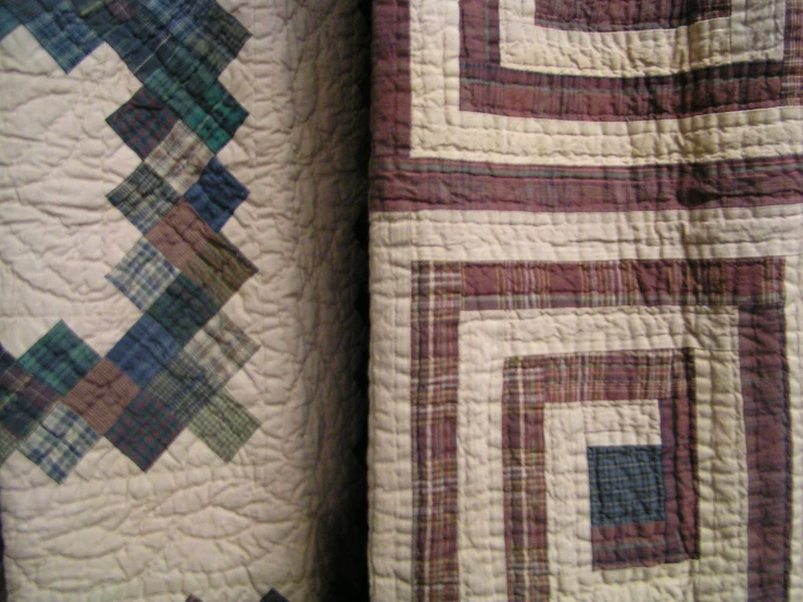 two beds made up with matching quilts and pillows