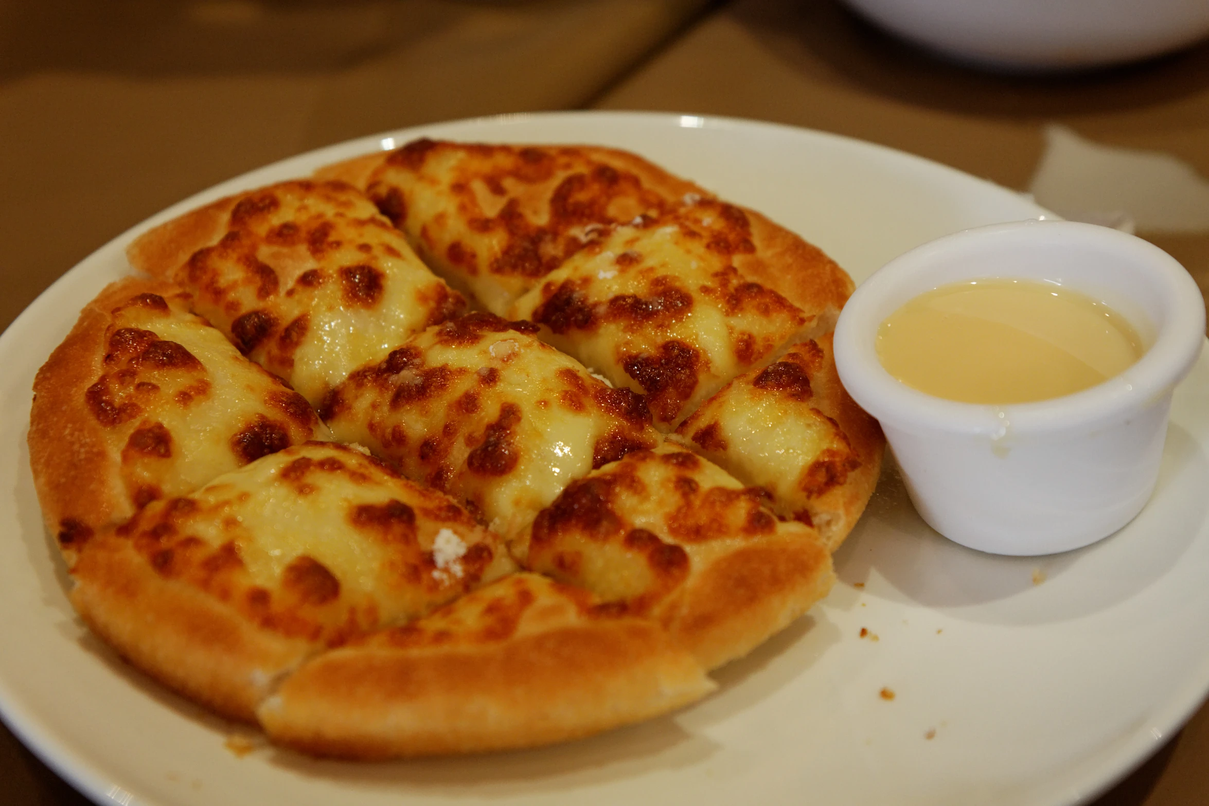 the plate is sitting on a table with the small white cup