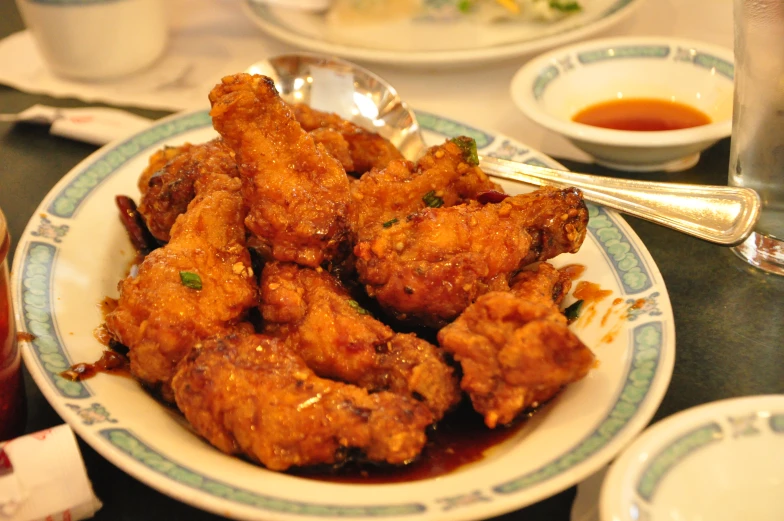 a plate of fried food with sauce on the side