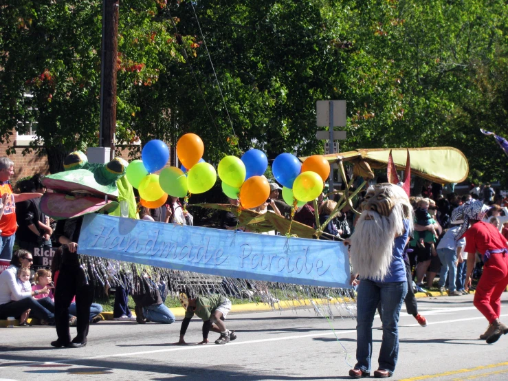 there is a parade with people walking down the street