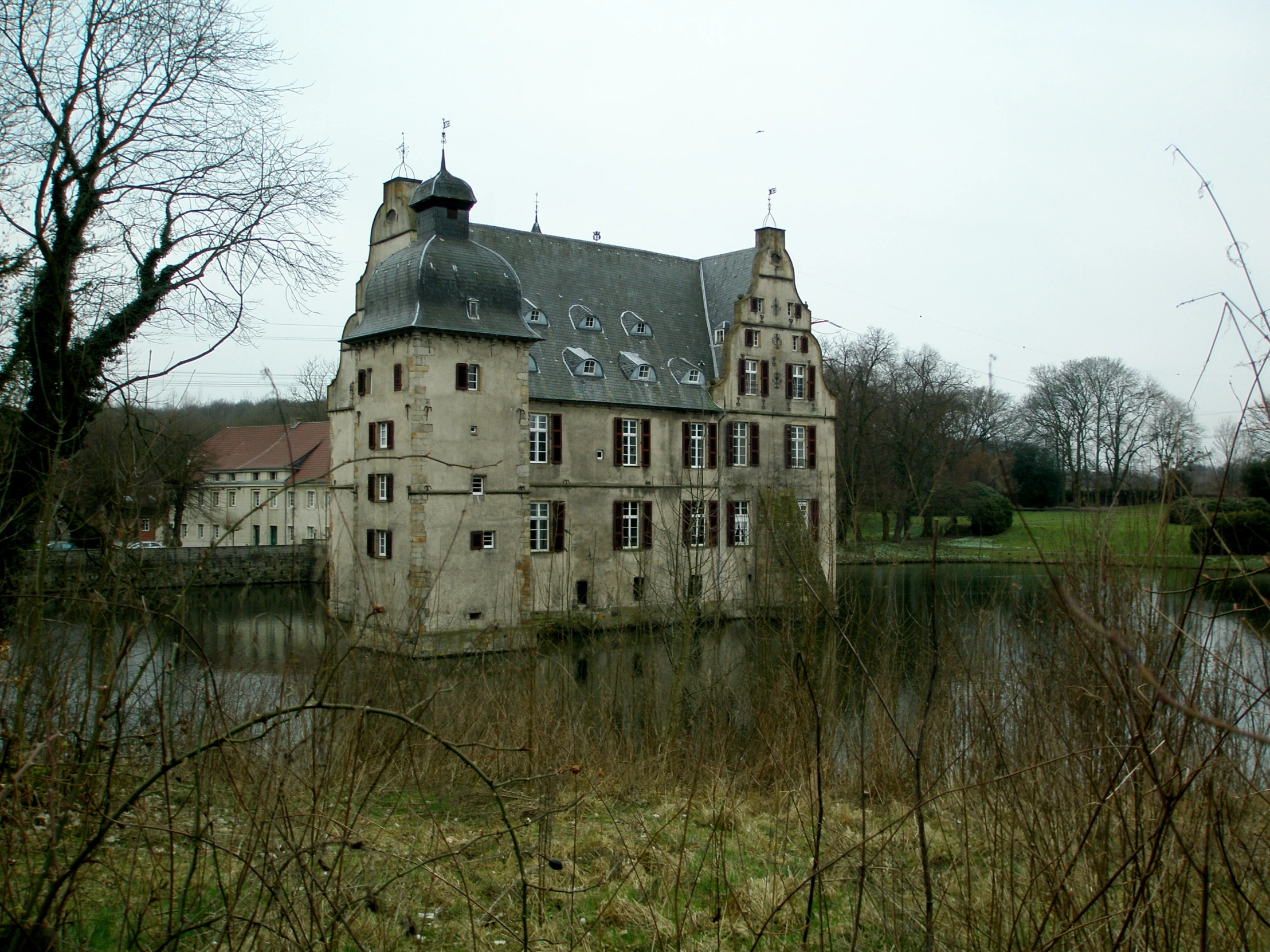 a big old building sitting next to a lake