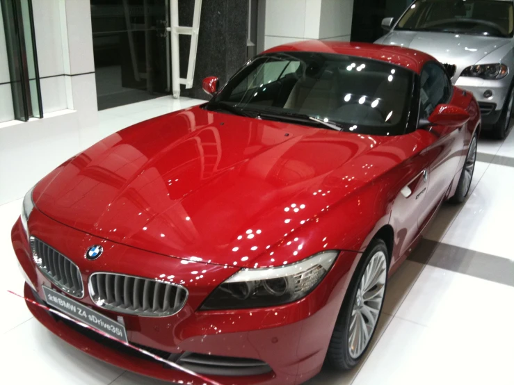 a shiny red bmw z4 car in a showroom