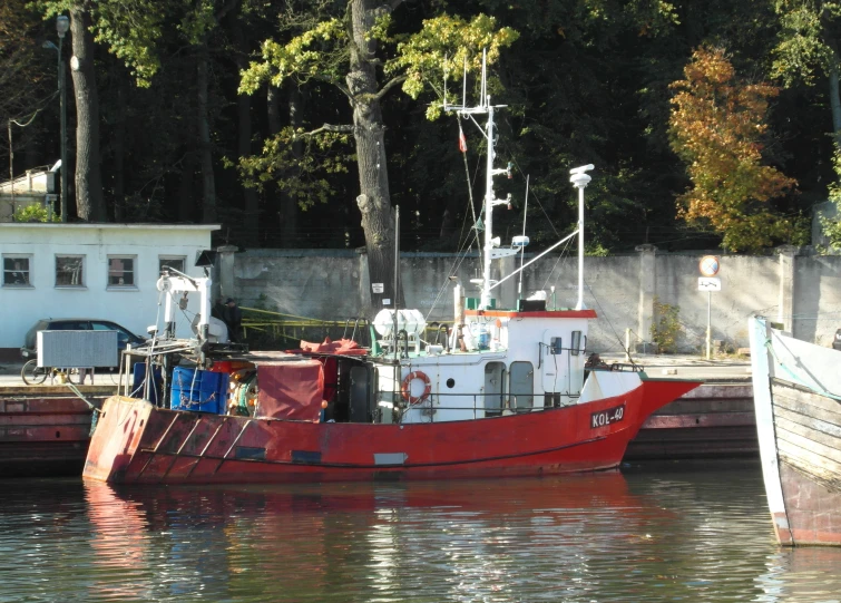 two boats docked in the water next to a dock