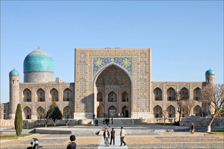 a group of people standing in front of a large building