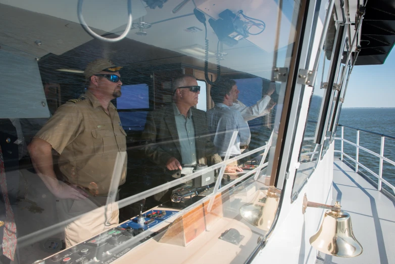 men stand near the window on a ship with a view