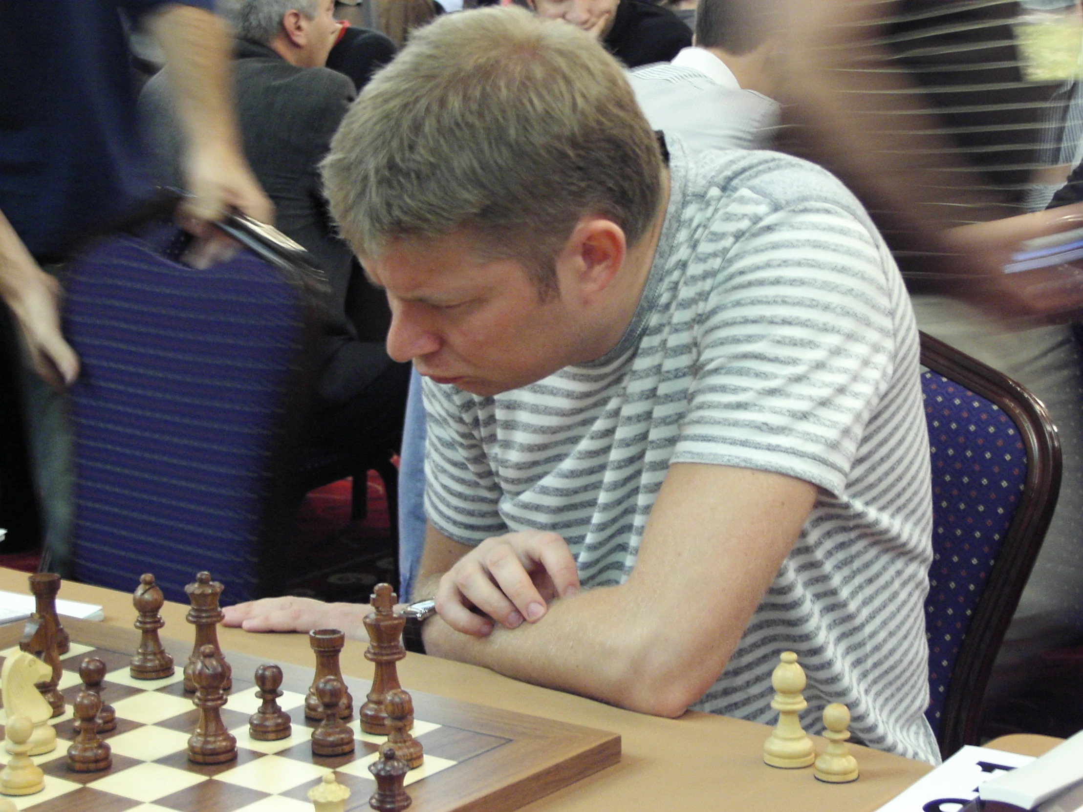 a man playing chess in a large room