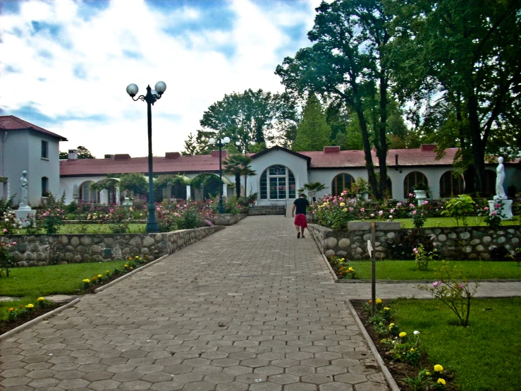 a woman walks down the walkway of her home