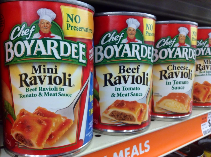 a shelf in a store holding canned food