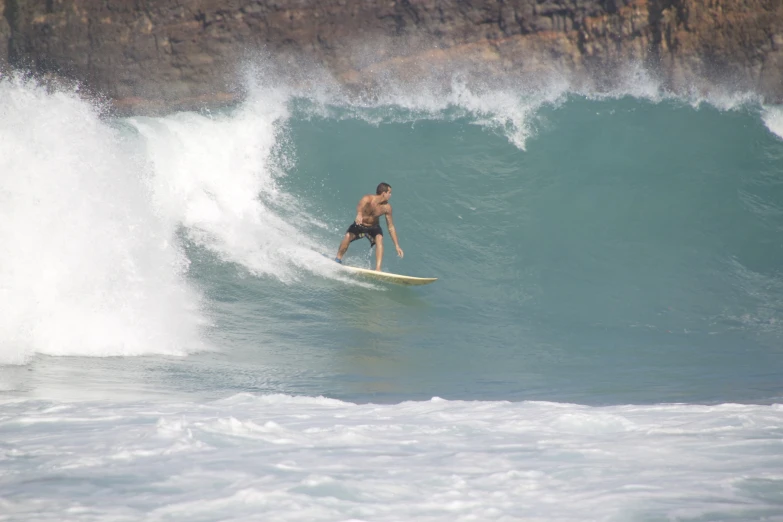 a man on a surfboard in the middle of a wave