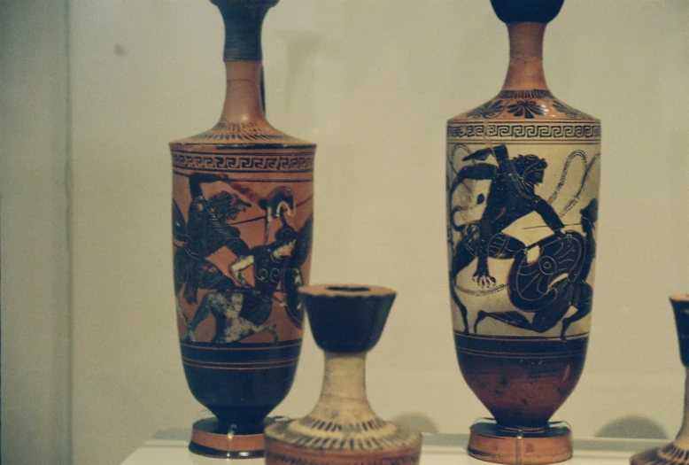 a group of vases with unique designs are on display