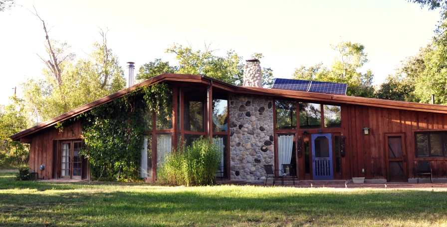 a house with vines growing on the outside and in front of it