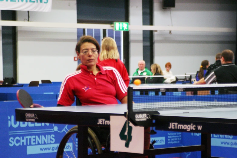 two people standing in front of a ping pong table