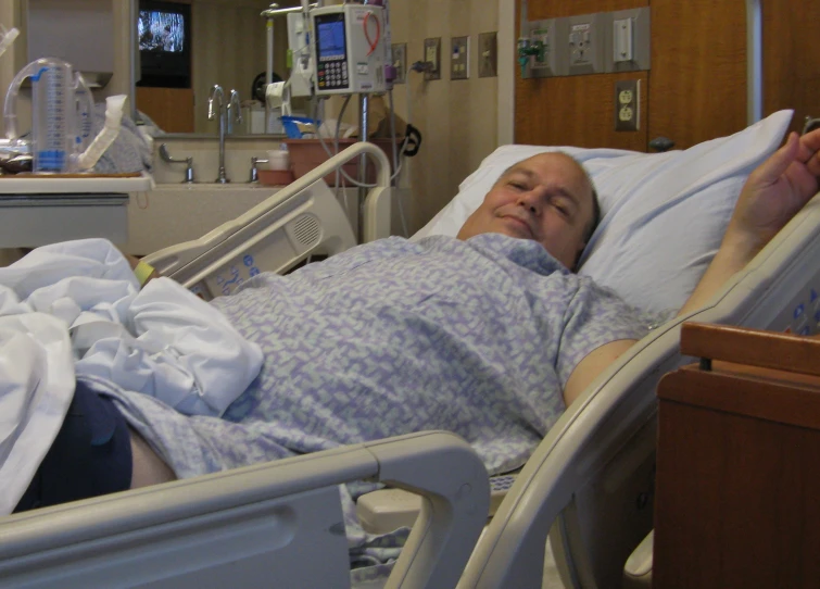 an older person lays in a hospital bed