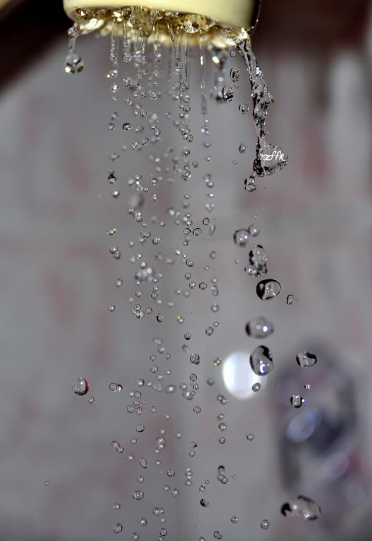 water running down the faucet from above the shower head