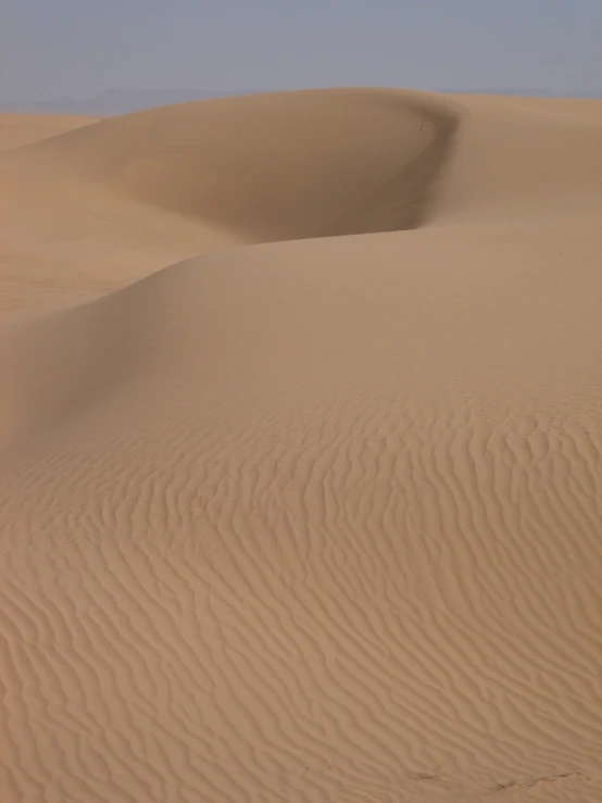 ripples in the desert sand as if it were being raining