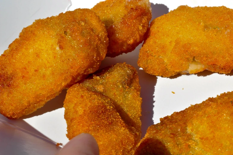 fried fried food placed on top of a white tray