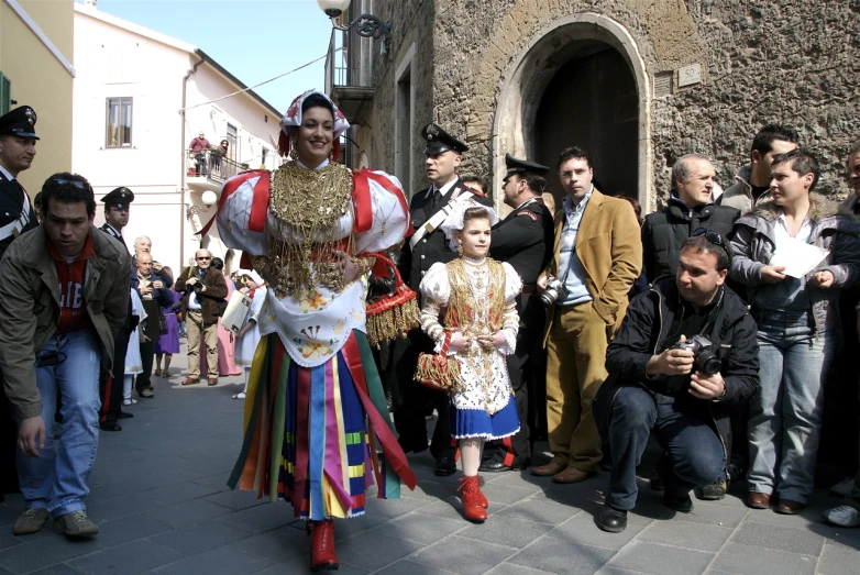 a man with colorful clothing walking down the street