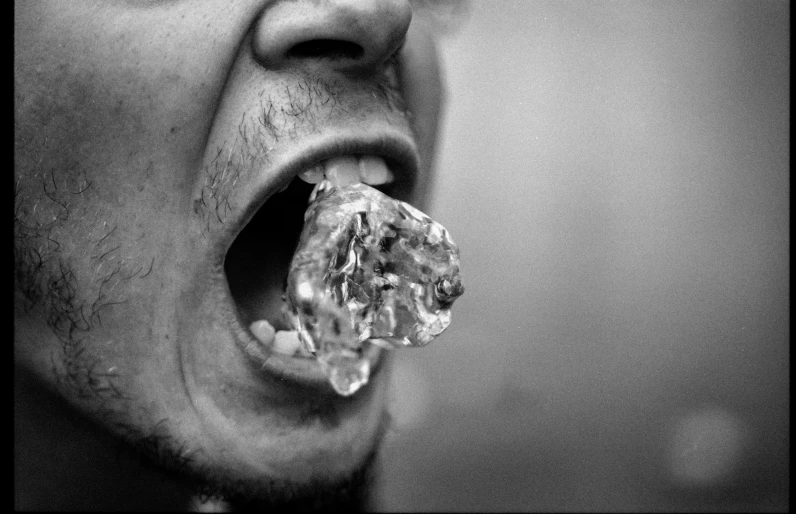 a man eating food while making an angry face