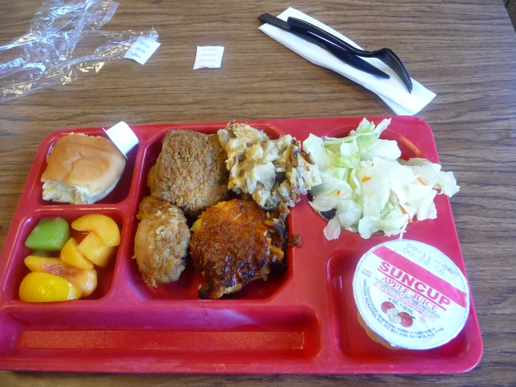 a plate with a red tray on it holding several types of food