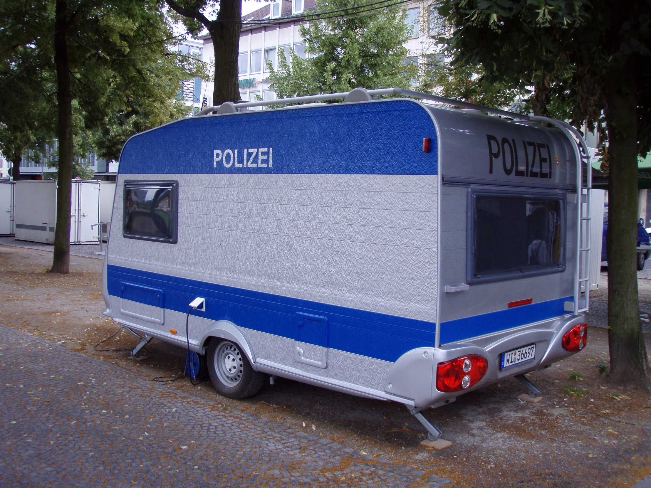 a small vehicle in front of some trees