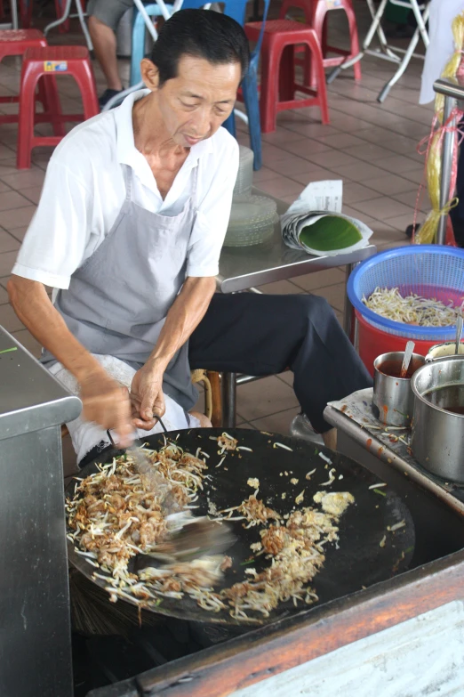 a man is preparing some food on a grill