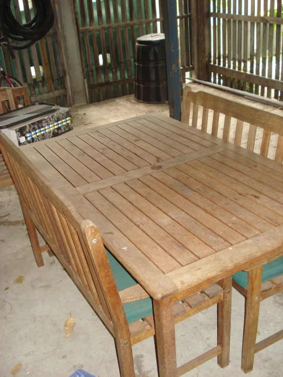 an outdoor table and chairs with two audio equipment near by